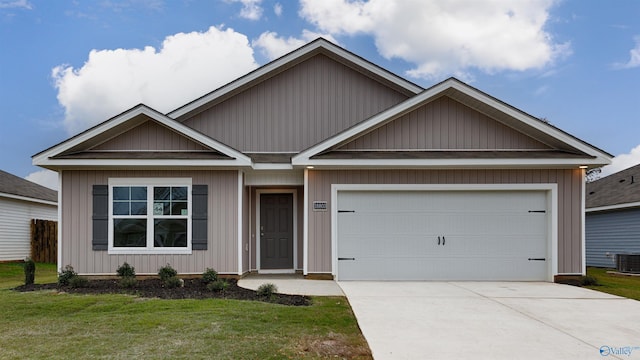 view of front of property with cooling unit, a garage, and a front lawn