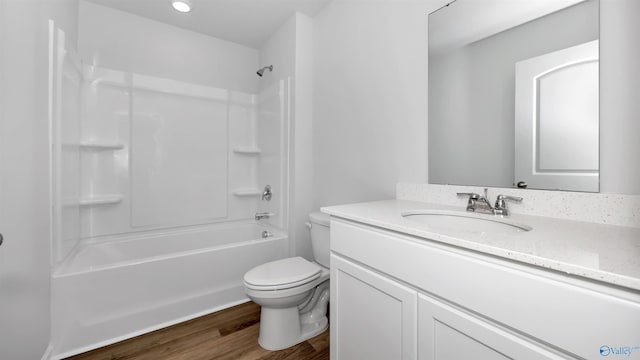 full bathroom with vanity, toilet, tub / shower combination, and hardwood / wood-style floors