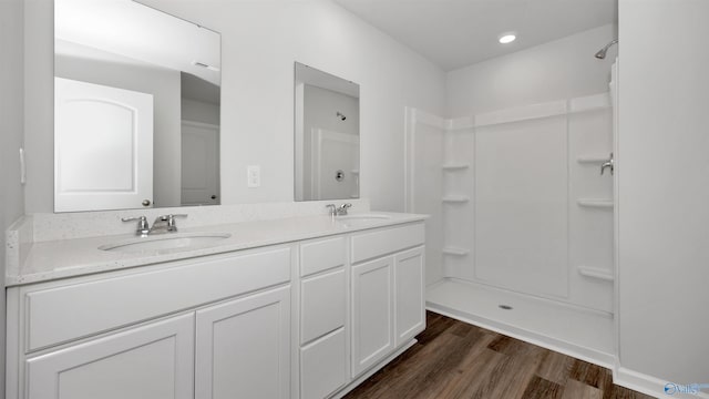 bathroom with vanity, hardwood / wood-style floors, and walk in shower