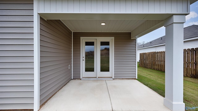 property entrance with a yard and a patio area