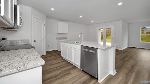 kitchen with sink, white cabinetry, light stone counters, an island with sink, and stainless steel appliances