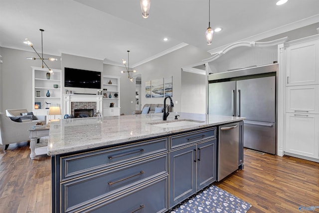 kitchen with light stone countertops, dark hardwood / wood-style flooring, a brick fireplace, and stainless steel dishwasher