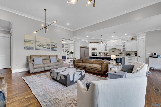 living room with ornamental molding, decorative columns, and hardwood / wood-style flooring