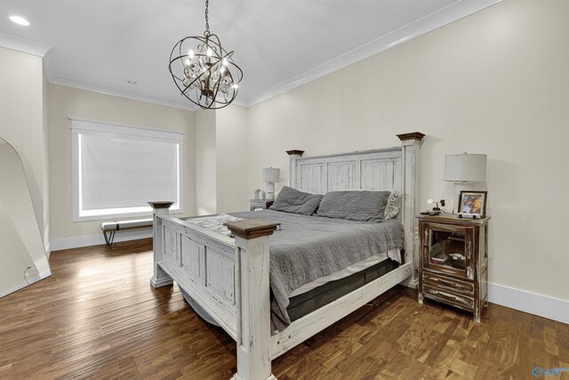 bedroom with crown molding, dark hardwood / wood-style flooring, and a chandelier