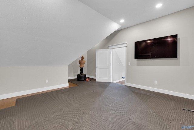 bonus room featuring carpet floors and vaulted ceiling