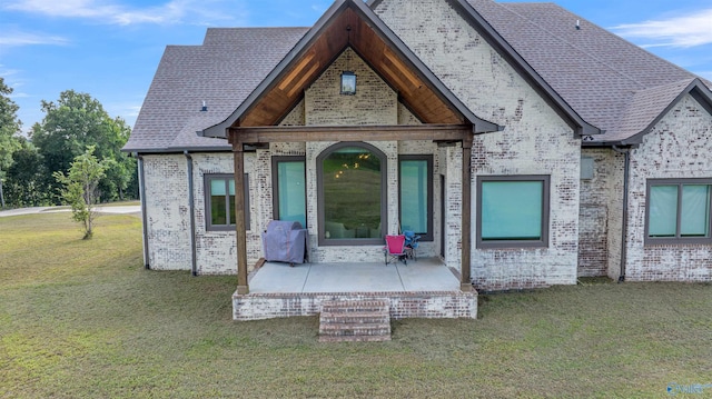 back of house with a yard and a patio area