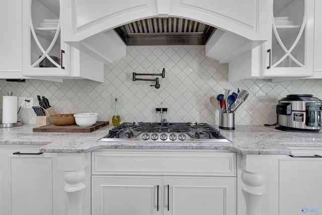 kitchen featuring white cabinets, backsplash, and stainless steel gas cooktop