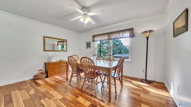 dining room featuring ceiling fan, ornamental molding, and light hardwood / wood-style floors