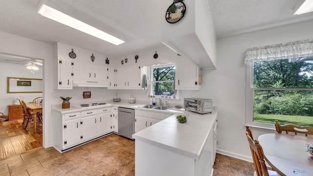 kitchen featuring sink, a textured ceiling, dishwasher, kitchen peninsula, and white cabinets