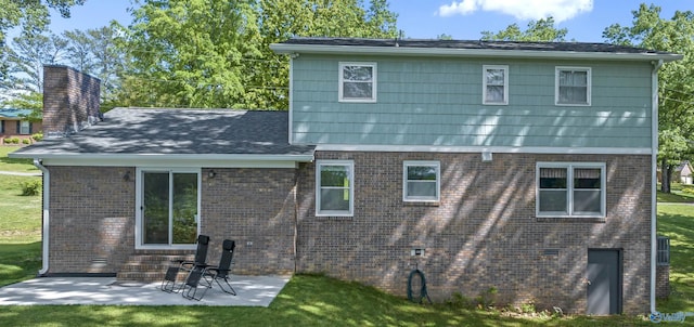 rear view of property with a lawn and a patio area