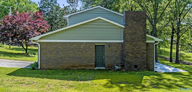 view of side of home with a lawn