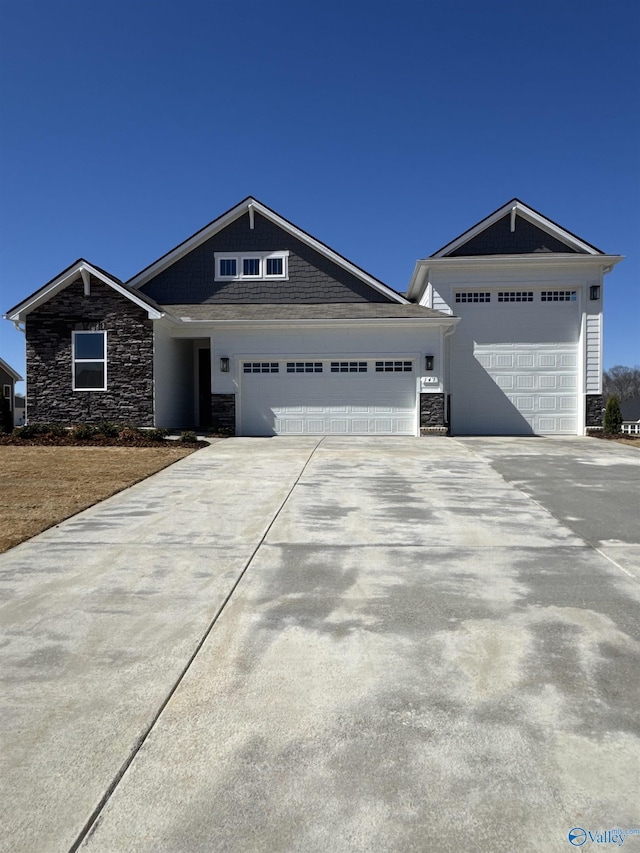 view of front facade with a garage, stone siding, and driveway