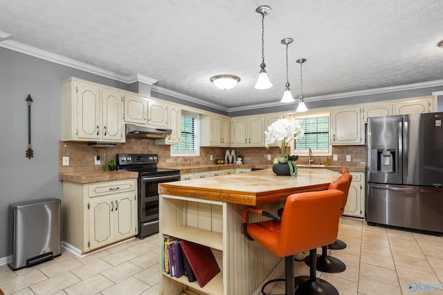 kitchen with light tile patterned floors, under cabinet range hood, appliances with stainless steel finishes, a sink, and a center island