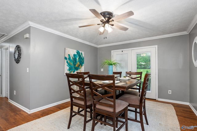 dining room with a textured ceiling, wood finished floors, a ceiling fan, and baseboards
