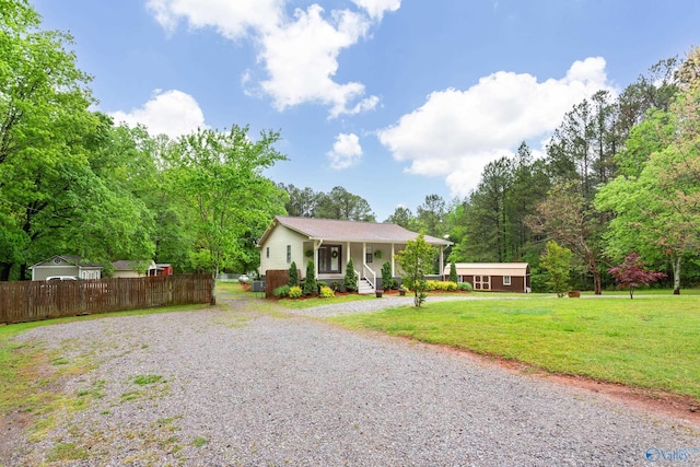 view of front of house with a porch, a front lawn, driveway, and fence