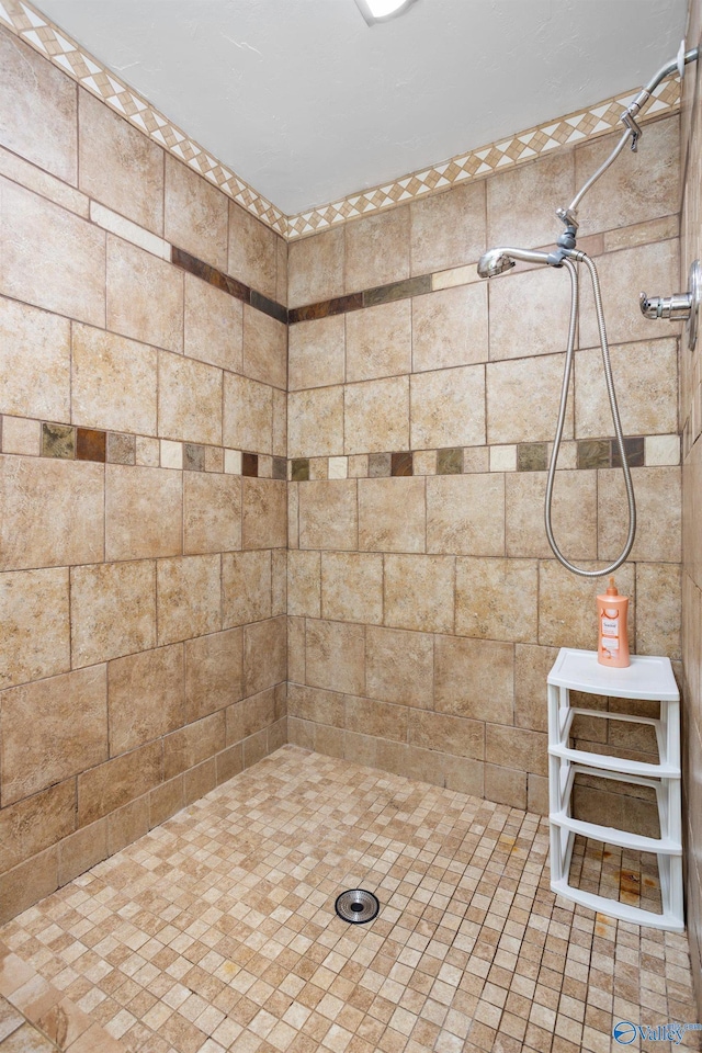 full bath with a tile shower