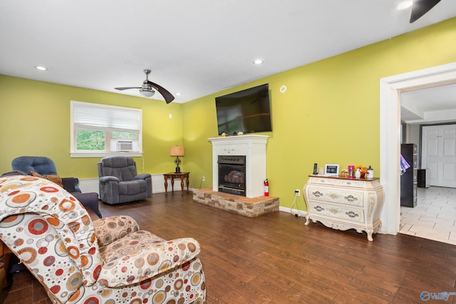 living room with recessed lighting, wood finished floors, cooling unit, ceiling fan, and a glass covered fireplace