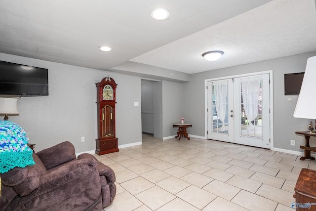 living room with baseboards, recessed lighting, and french doors