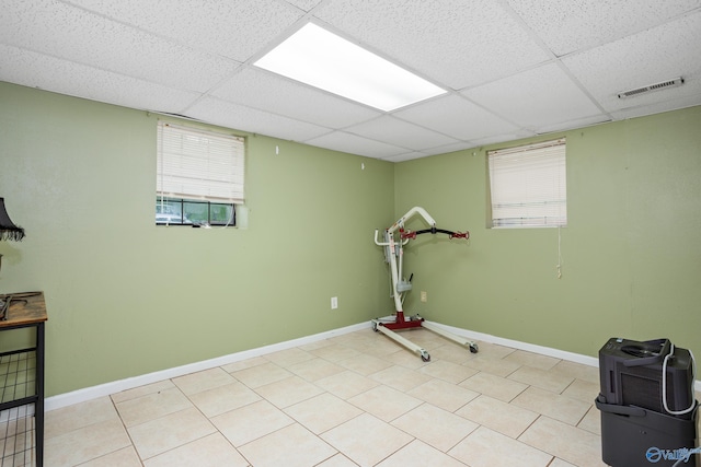 workout room with a wealth of natural light, visible vents, a paneled ceiling, and baseboards