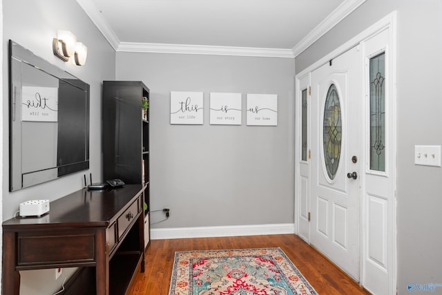 entrance foyer with baseboards, wood finished floors, and crown molding
