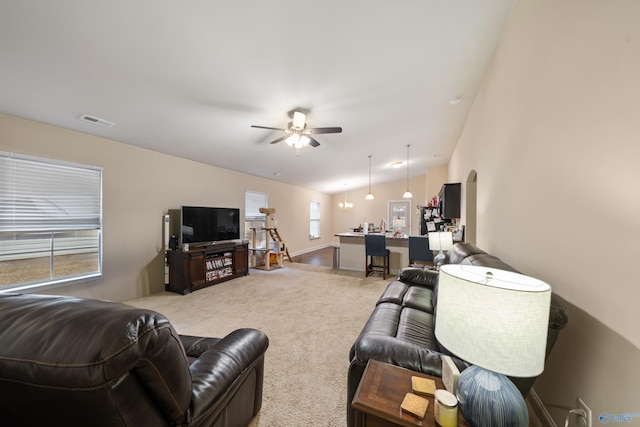 carpeted living room featuring vaulted ceiling and ceiling fan