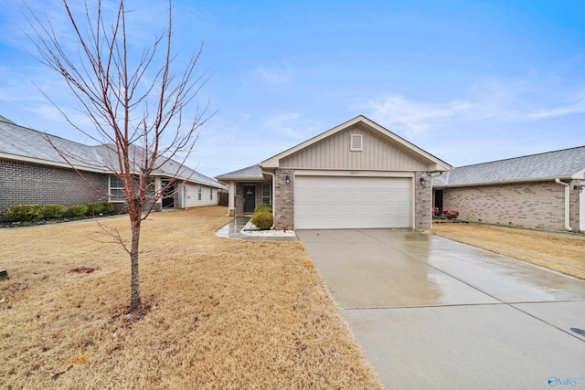 single story home with a garage and a front lawn