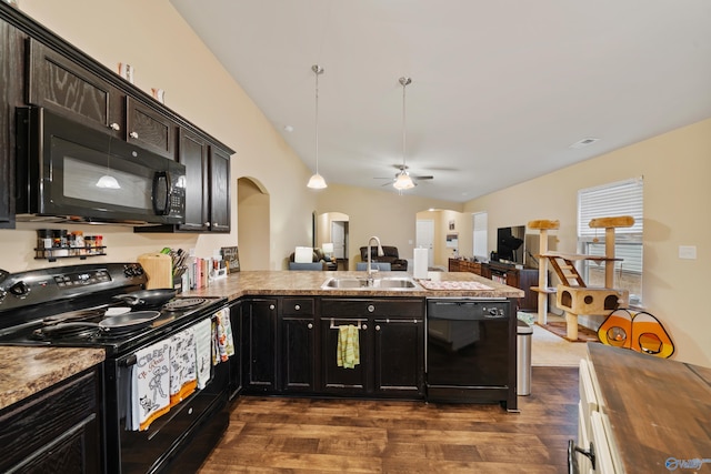 kitchen featuring dark hardwood / wood-style floors, black appliances, sink, hanging light fixtures, and kitchen peninsula