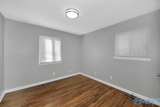 spare room with hardwood / wood-style floors