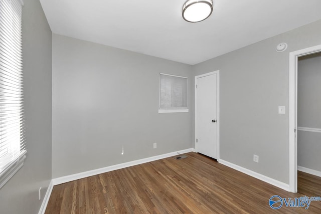 unfurnished bedroom featuring dark hardwood / wood-style floors