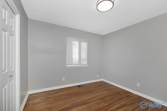 spare room featuring dark hardwood / wood-style floors