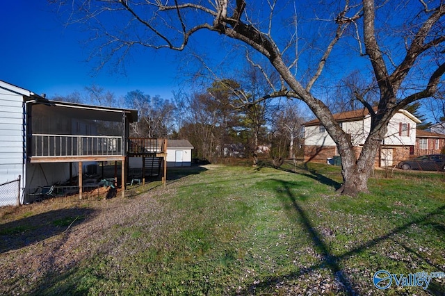 view of yard with a wooden deck and a sunroom