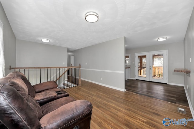 living room featuring french doors and dark hardwood / wood-style floors