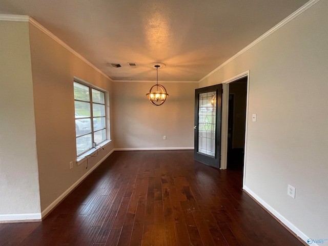 empty room with ornamental molding, dark hardwood / wood-style floors, and a notable chandelier