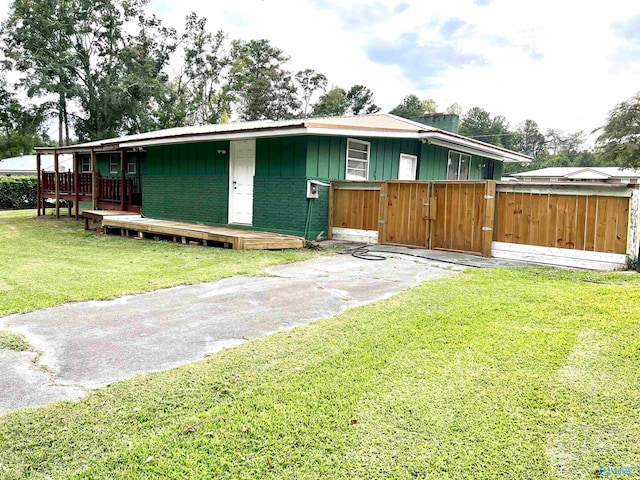 view of front of house featuring a front yard and a wooden deck