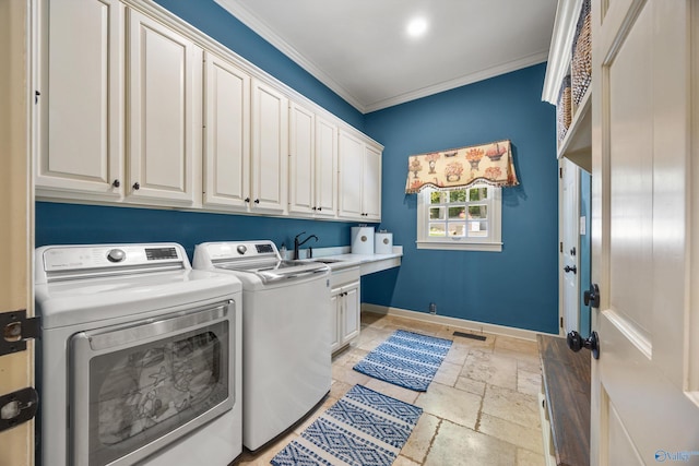 laundry room with cabinets, ornamental molding, washer and clothes dryer, and sink