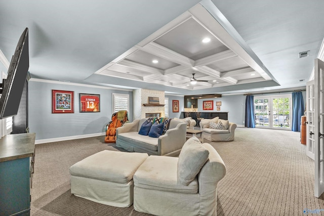 carpeted living room with beamed ceiling, ornamental molding, coffered ceiling, ceiling fan, and a brick fireplace