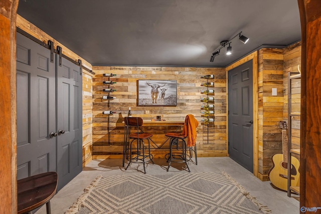 interior space featuring a barn door and wood walls