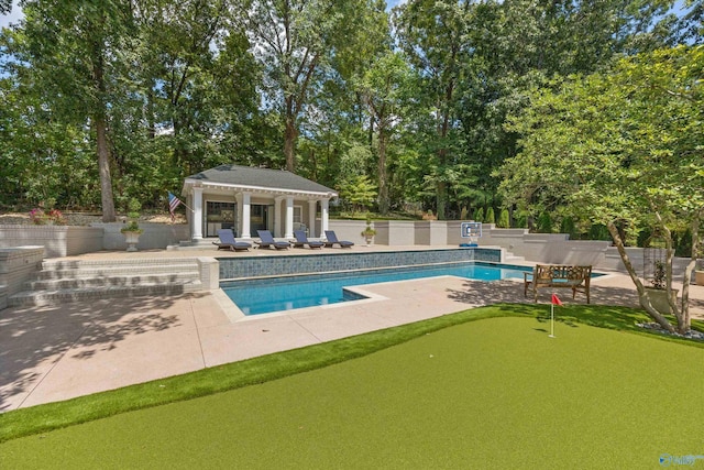 view of pool with an outdoor structure and a patio area