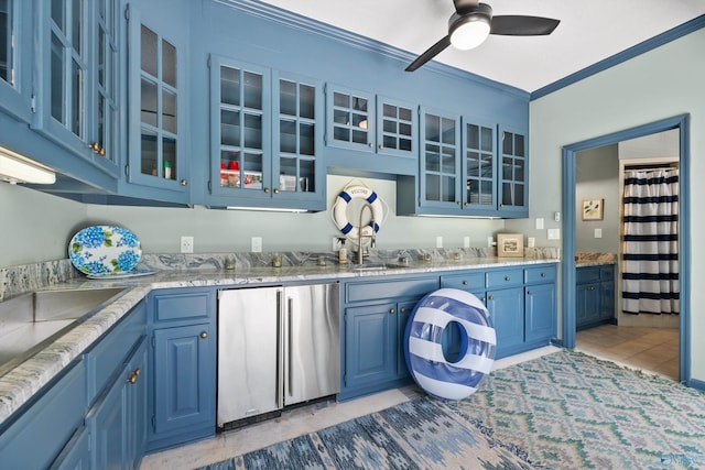 kitchen with light stone counters, crown molding, blue cabinetry, and stainless steel refrigerator