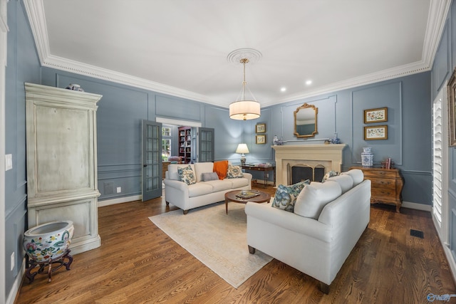 living room with ornamental molding and dark wood-type flooring