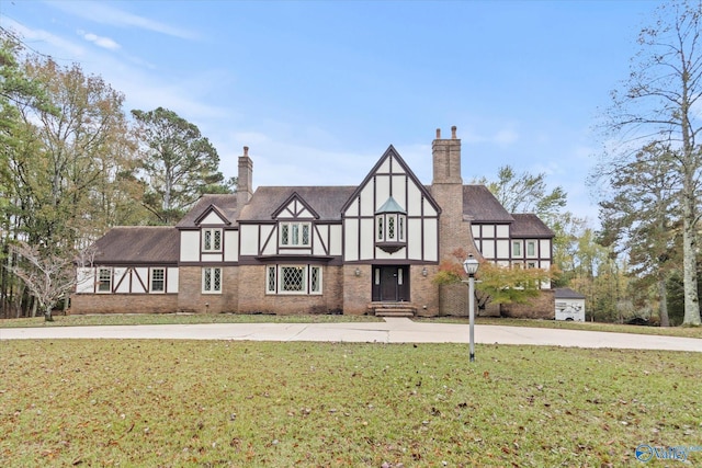 tudor home with a front yard