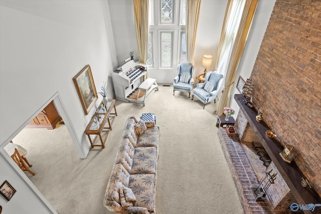 living room with a towering ceiling and carpet floors