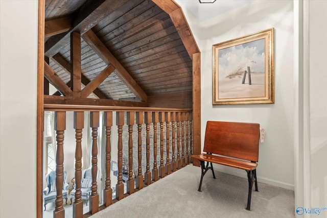 sitting room with wood ceiling, lofted ceiling with beams, and carpet floors