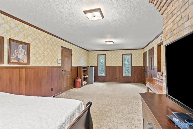 bedroom with wood walls, a textured ceiling, and carpet floors