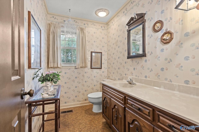 bathroom with vanity, toilet, a textured ceiling, and crown molding