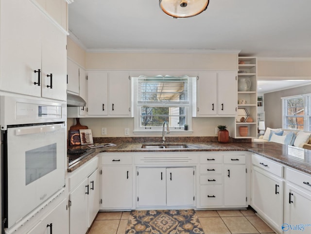 kitchen featuring white oven, ornamental molding, white cabinets, and sink