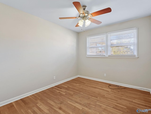 empty room with ceiling fan and light hardwood / wood-style flooring