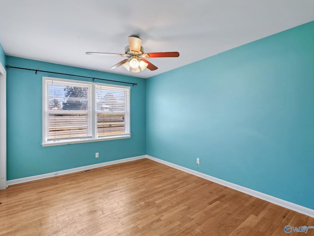 unfurnished room with ceiling fan and light wood-type flooring