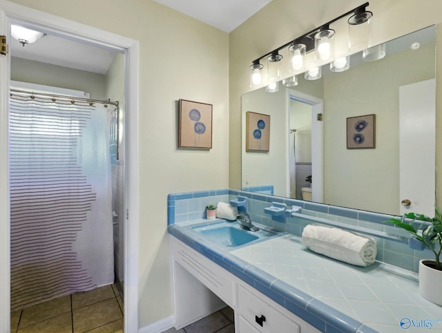 bathroom with walk in shower, tile patterned floors, and vanity