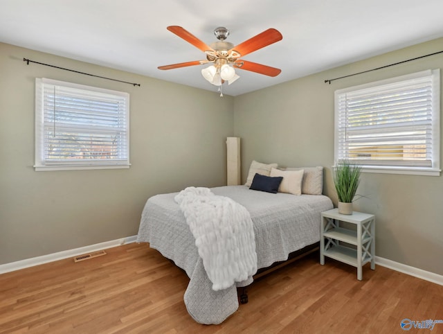 bedroom featuring light wood-type flooring and ceiling fan